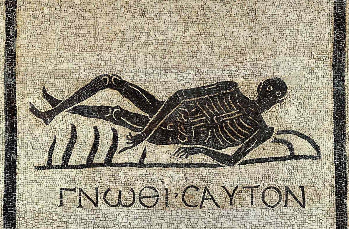 A Roman mosaic of a skeleton lying on its side above the Greek words gnōthi sauton, know thyself